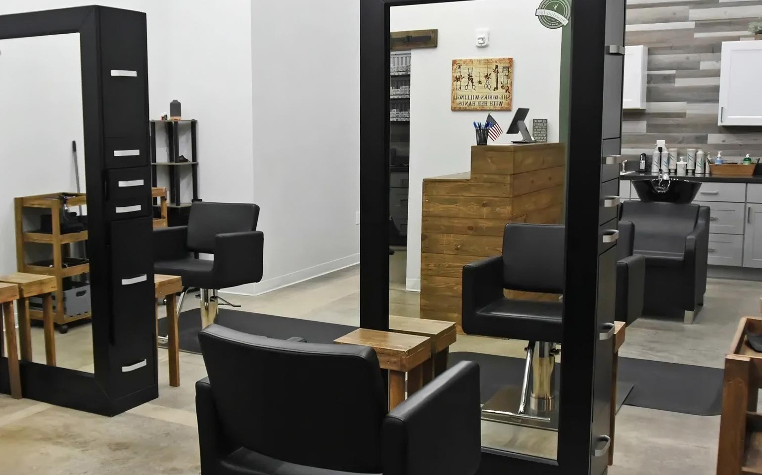 Interior of a modern, sleek salon with styling chairs and mirrors.