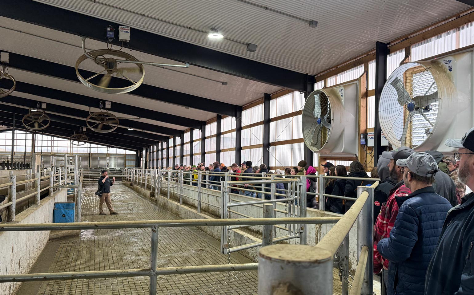 Luke Luchterhand, co-owner of Elusive Hill Dairy, describes the farm’s gate system, footbath and herd health monitoring system to participants at the 49th Annual Farm Tour.